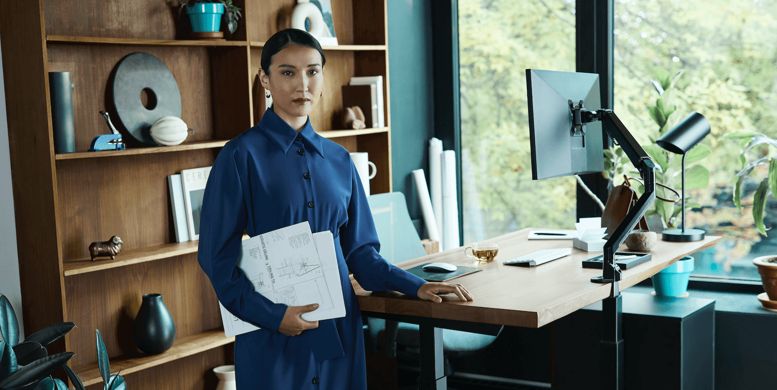 Customer with their live-edge walnut standing desk with ergonomic components