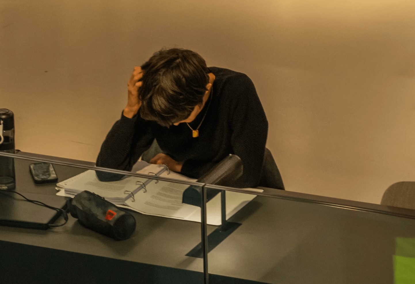 Person experiencing back pain at desk