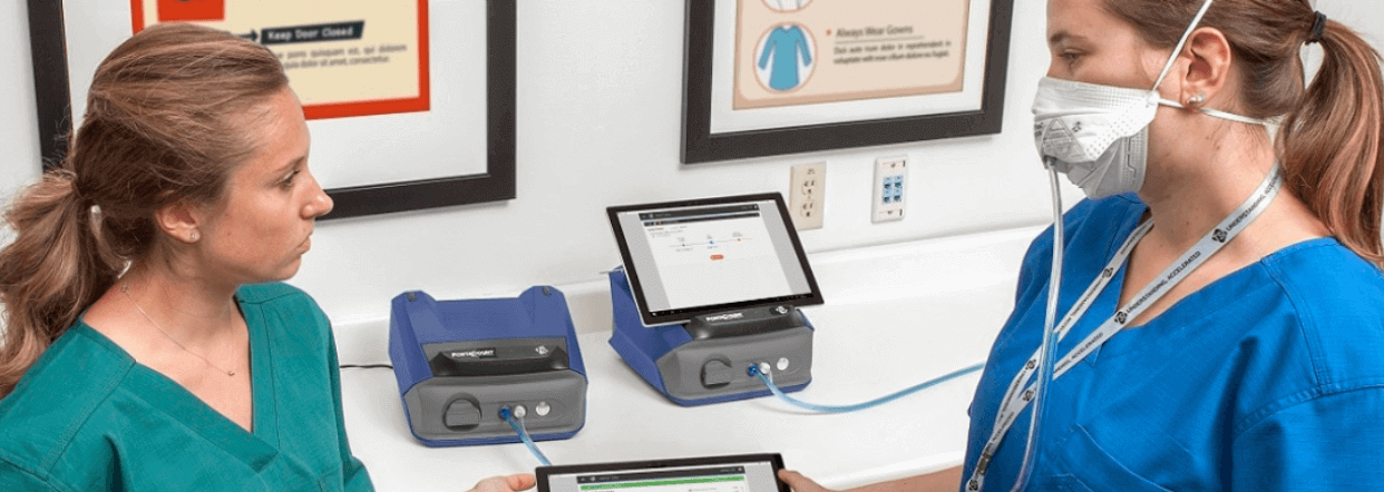 Two healthcare workers using a respirator