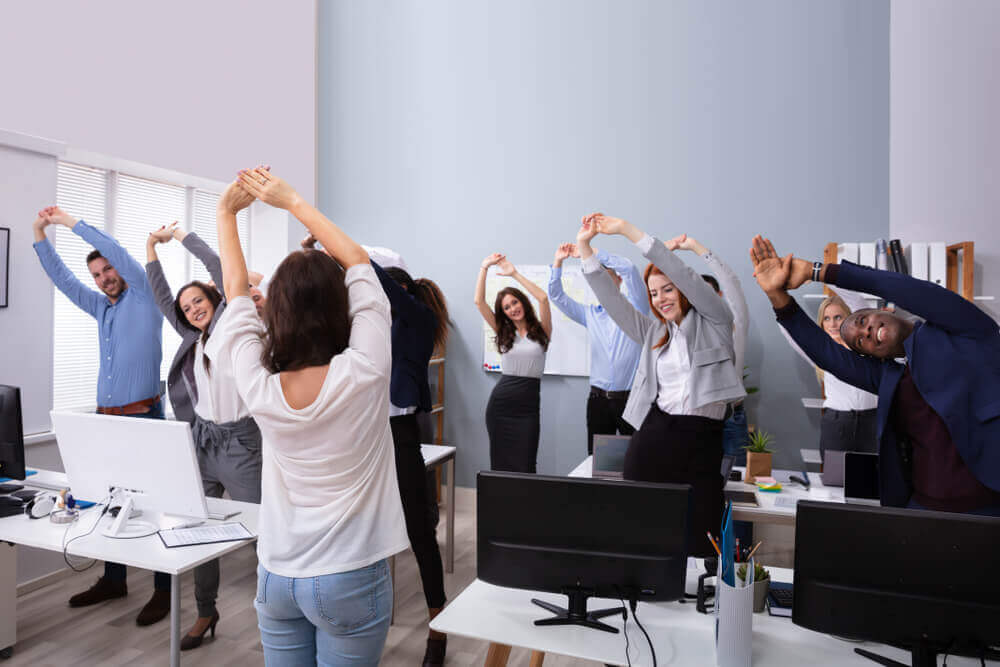 Team stretching in office